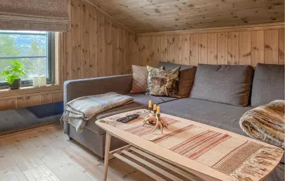 a living room with a couch and a table at 3 Bedroom Beautiful Home In Lesjaverk in Bjorli