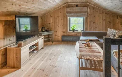 a living room with a couch and a table at 3 Bedroom Beautiful Home In Lesjaverk in Bjorli