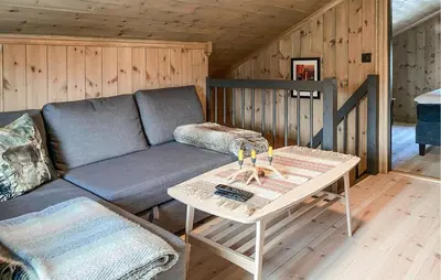a living room with a couch and a table at 3 Bedroom Beautiful Home In Lesjaverk in Bjorli