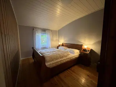 a bedroom with a bed with a window and a table at Home with a view in Lom