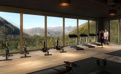 a gym with a large window with a view of the mountains at New apartment in Hemsedal Fjellandsbyen in Hemsedal