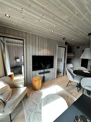 a living room with a couch and a tv at New apartment in Hemsedal Fjellandsbyen in Hemsedal