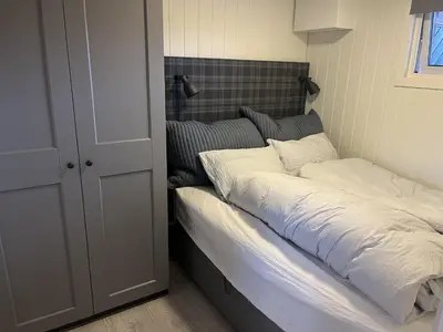 a bed with white sheets and pillows in a bedroom at Hovden Alpin Apartments in Bykle