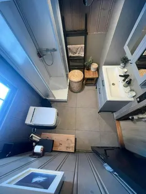 a small bathroom with a toilet and a sink at Modern Mountain Cabin With Views Over Slokovannet in Nore