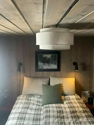 a bedroom with a bed with two pillows at Modern Mountain Cabin With Views Over Slokovannet in Nore