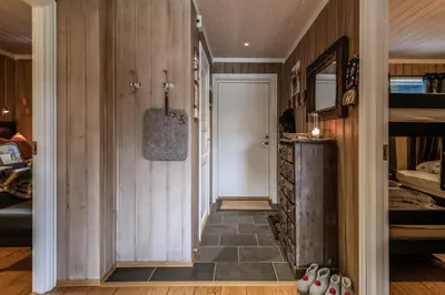 a hallway of a room with a bed and a door at Geilotunet Apartment - close to everything, free parking in garage, EV in Geilo