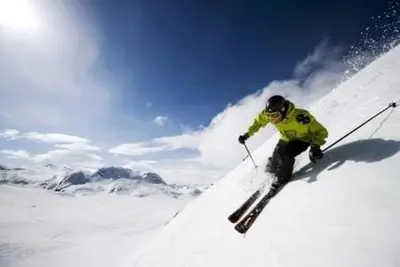 a man is skiing down a snow covered slope at Ski out ski in Luxus Hemsedal in Hemsedal