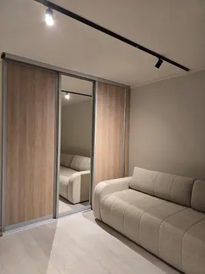 a living room with a couch and a bedroom at 28 sqm studio apartment in the heart of Leirvik in Stord