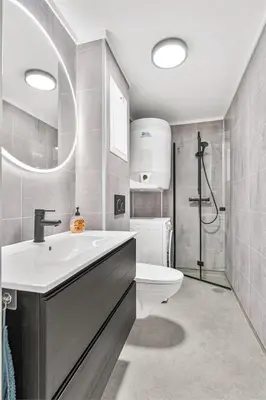 a bathroom with a sink and a toilet at 28 sqm studio apartment in the heart of Leirvik in Stord