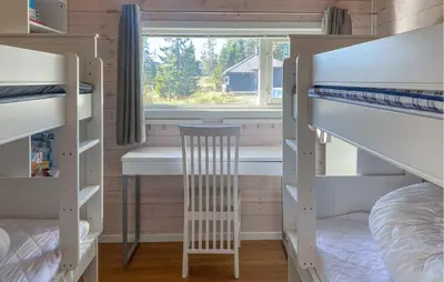 a room with two bunk beds and a chair at 3 Bedroom Cozy Home In Sjusjøen in Sjusjøen