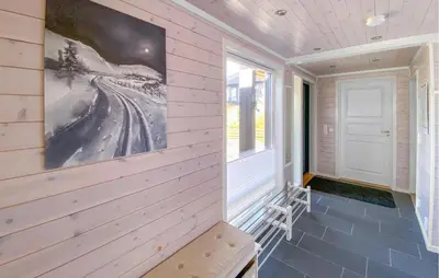 a porch with a bench and a painting on the wall at 3 Bedroom Cozy Home In Sjusjøen in Sjusjøen