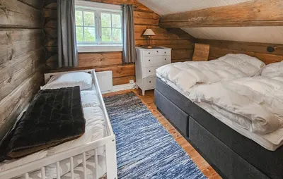 a bedroom with a bed and a dresser and a window at Cozy Home In Rauland With Wifi in Rauland