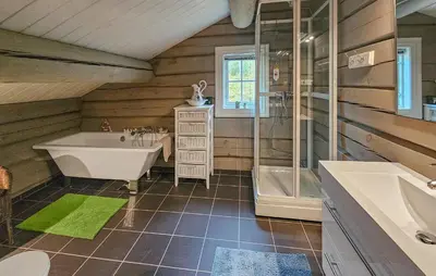a bathroom with a tub and a shower and a sink at Cozy Home In Rauland With Wifi in Rauland