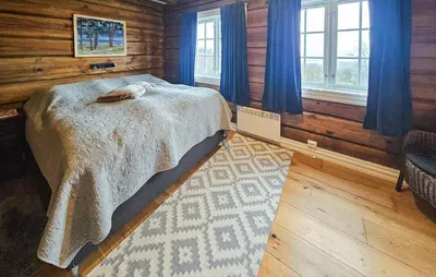 a bedroom with a bed in a wooden cabin at Cozy Home In Rauland With Wifi in Rauland