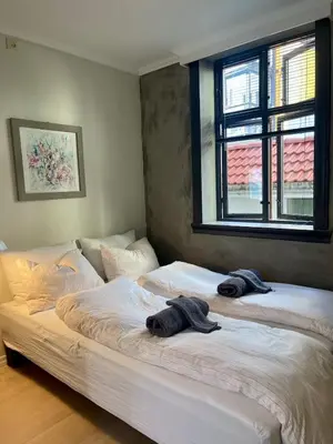 two beds with towels on top of them in a bedroom at Central studio apartment in Bergen