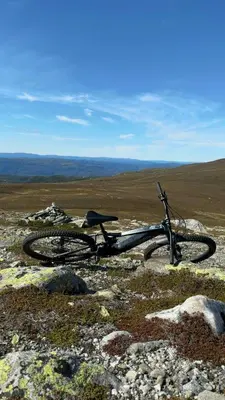 a bike laying on top of a rocky field at Mountain Cabin With Panoramic Views In Norefjell in Noresund