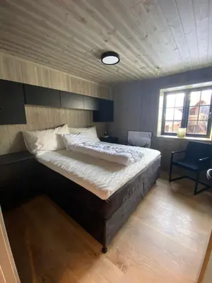 a bedroom with a large bed in a room at Hovden Alpin Lodge Appartement in Bykle