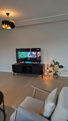 a living room with a large flat screen tv at Apartment in Ålesund in Ålesund