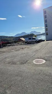 a road with a car parked next to a building at Apartment in Ålesund in Ålesund