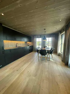 a kitchen with a table and chairs in a room at New cabin in Slåseterlia at Skeikampen in Svingvoll