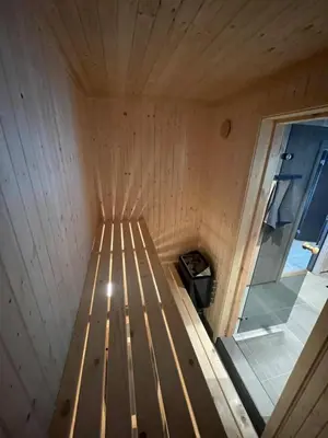 a wooden interior of a sauna with a window at New cabin in Slåseterlia at Skeikampen in Svingvoll