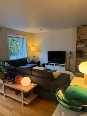 a living room with a couch and a tv at Gimleveien 36G in Bergen