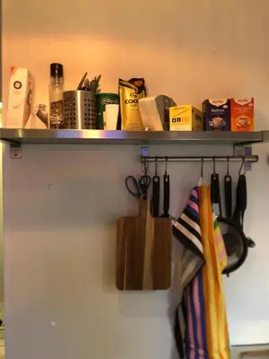 a shelf with a bunch of kitchen utensils at Compact living with all you need, close to the centre! in Røros