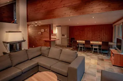 a living room with a couch and a dining room at Bakkebyvegen 7B in Trysil