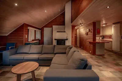 a living room with a couch and a table at Bakkebyvegen 7B in Trysil