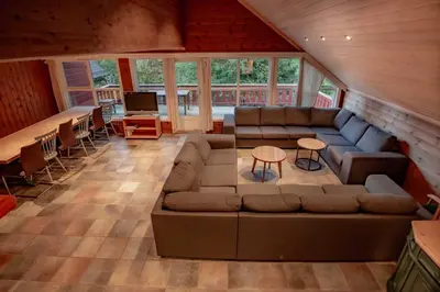 a large living room with a couch and a table at Bakkebyvegen 7B in Trysil