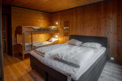 a bedroom with a bed and two bunk beds at Bakkebyvegen 7B in Trysil