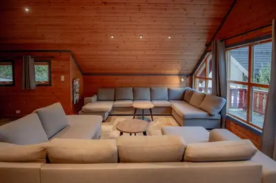 a living room with couches and a table at Bakkebyvegen 7A in Trysil