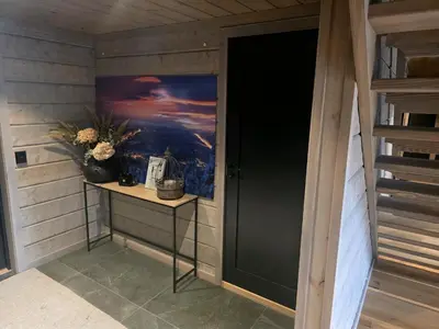 a door in a room with a painting on the wall at Unique hytta with jacuzzi, sauna, 7 bedrooms in Trysil