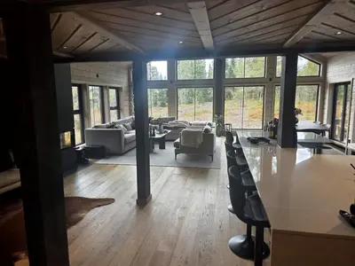 a large living room with a table and chairs at Unique hytta with jacuzzi, sauna, 7 bedrooms in Trysil
