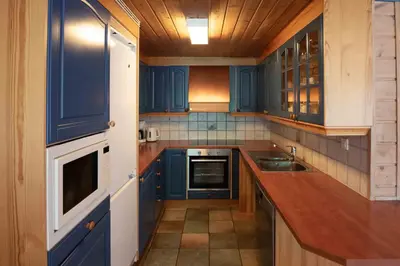 a kitchen with blue cabinets and a sink at Bakkebyvegen 13A in Trysil