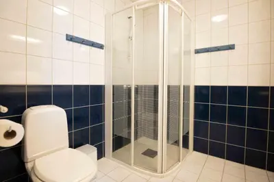 a bathroom with a toilet and a glass shower at Bakkebyvegen 13A in Trysil