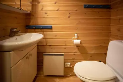 a bathroom with a white toilet and a sink at Bakkebyvegen 13A in Trysil