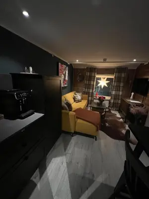 a living room with a yellow couch and a table at Charming apartment with lodgefeeling in Hemsedal