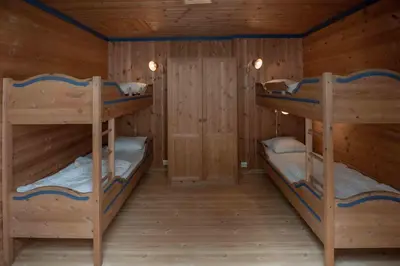 two bunk beds in a cabin with wooden walls at Bakkebyvegen 13B in Trysil