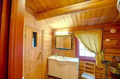 a bathroom with a sink in a wooden cabin at Timber Cabin With Mountain View in Beitostøl