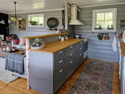 a kitchen with blue walls and a counter top at Cozy Family Cabin At Hamlagrø in Vossevangen