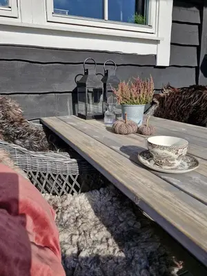a wooden table with a bowl and plates on it at Cozy Family Cabin At Hamlagrø in Vossevangen