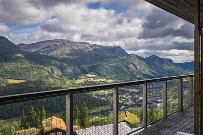 a view of the mountains from the balcony of a house at Large Ski in-Ski out Apartment for Groups in Hemsedal