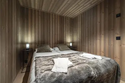 a bedroom with a bed with two towels on it at Nyørk Chalet, Hemsedal in Hemsedal
