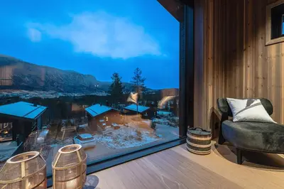 a room with a large window with a chair and a view at Nyørk Chalet, Hemsedal in Hemsedal