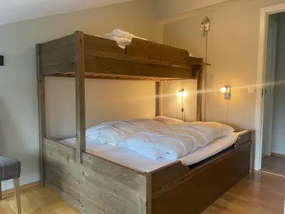 a large wooden bunk bed in a room at Hjemmekoselig Toppleilighet I Sentrum in Beitostøl