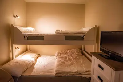 a bedroom with two bunk beds and a television at Høyfjellsgrend 961, 36b in Trysil