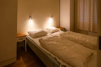 a bed in a room with two pillows on it at Høyfjellsgrend 961, 36b in Trysil