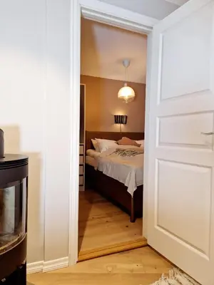 a bedroom with a bed and a white door at King Bed Renovated and Cozy Near Bryggen in Bergen