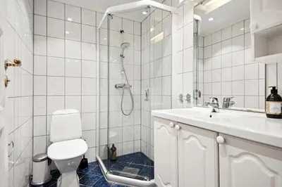 a bathroom with a shower and a toilet and a sink at Torgalmenningen Town Square, Yet quiet, Elevator in building in Bergen